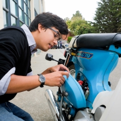 Photo of student working on motorbike