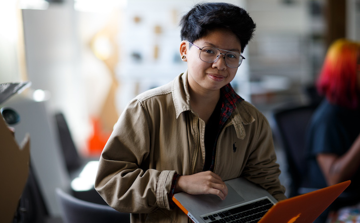 Student with orange laptop